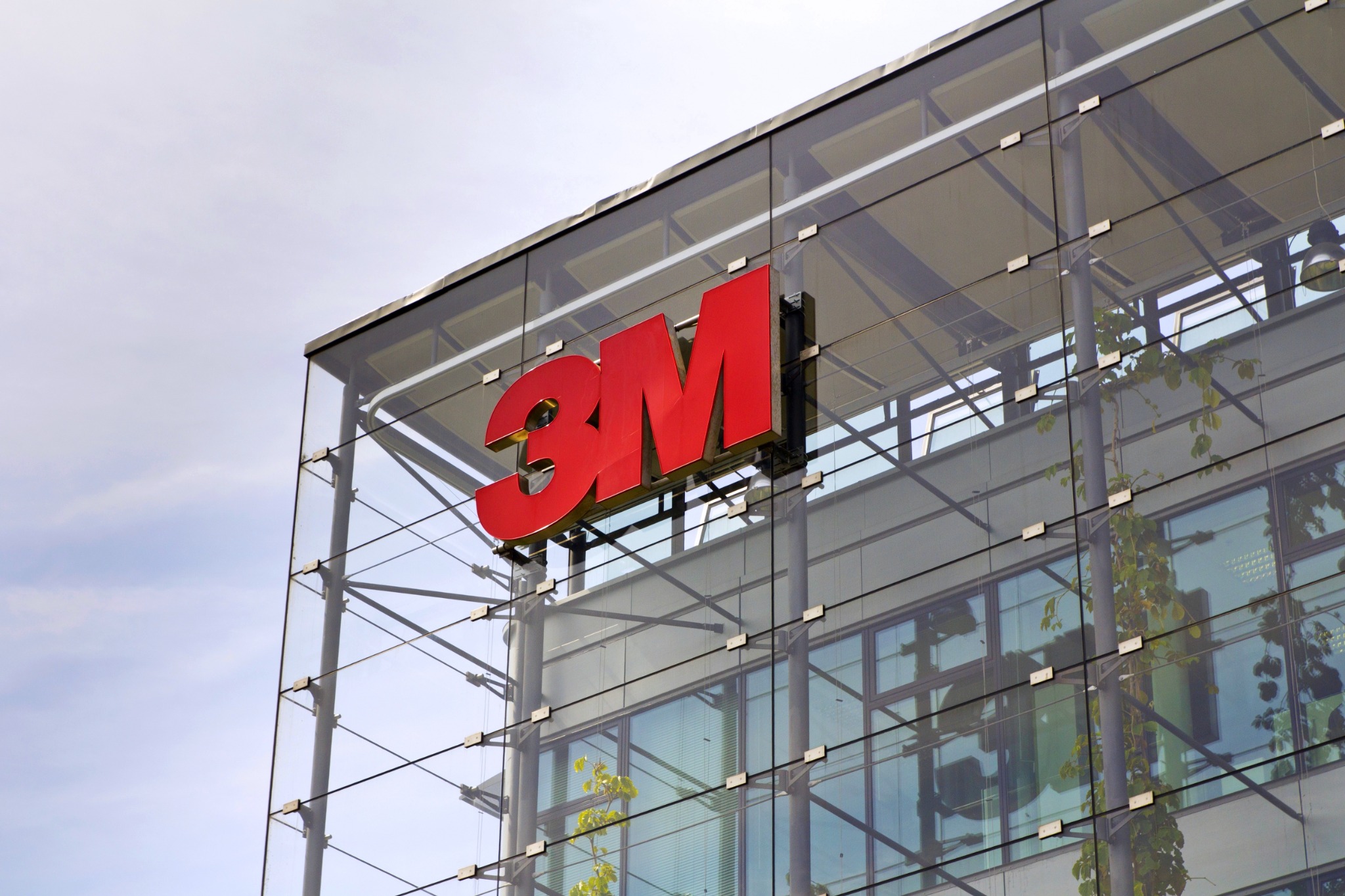 The red 3M logo mounted on the glass exterior of a company building